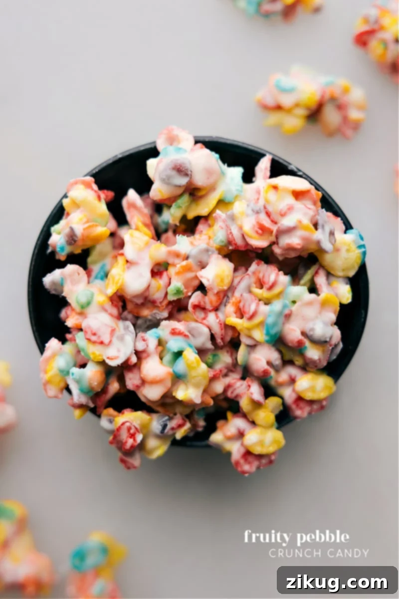 Overhead image of the Fruity Pebble Crunch Candy in clusters on parchment paper, showcasing vibrant colors