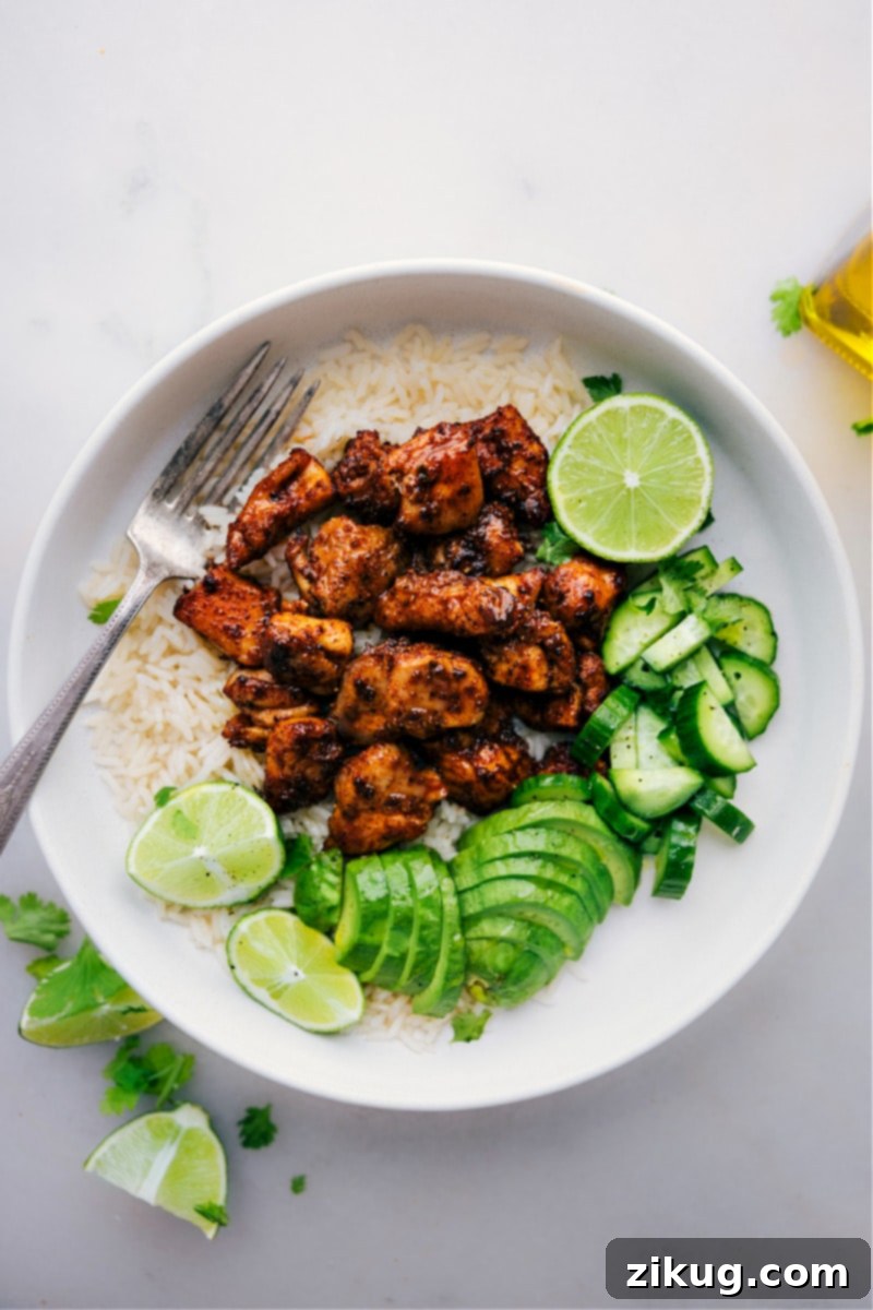 Overhead image of the Chipotle Chicken ready to be served in a bowl, garnished with fresh cilantro and lime