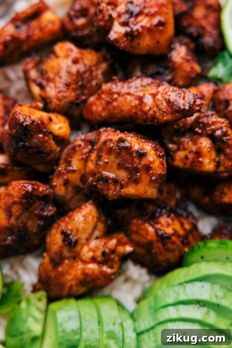 Up-close overhead image of the Chipotle Chicken, showing its caramelized edges and juicy interior, garnished with fresh cilantro.