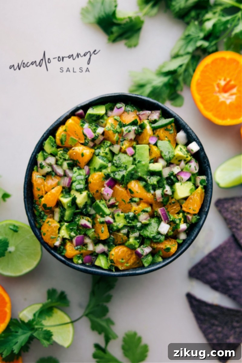 A close-up shot of Avocado-Orange Salsa in a white bowl, garnished with fresh cilantro, ready to be enjoyed as a refreshing dip.