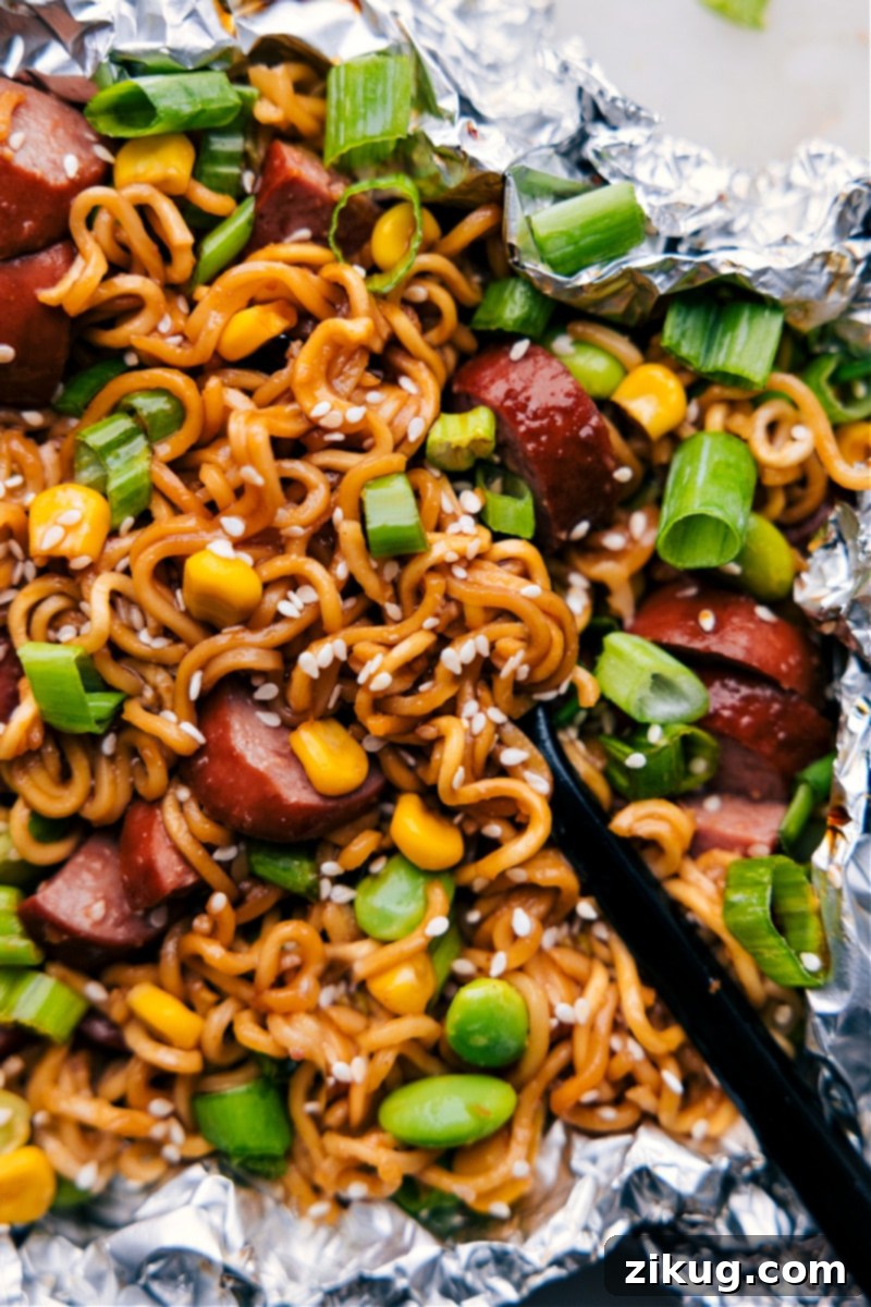 Ready-to-Enjoy: Perfectly Cooked and Garnished Foil Pack Ramen Noodles Overhead image of the delicious Foil Pack Ramen Noodles dish, garnished and ready to be enjoyed