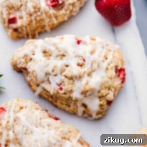 Freshly baked strawberry scones with glaze on top, ready to be enjoyed.