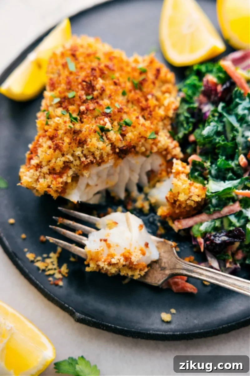Image of the Baked Cod with a bite out of it, showcasing its crispy topping and flaky interior