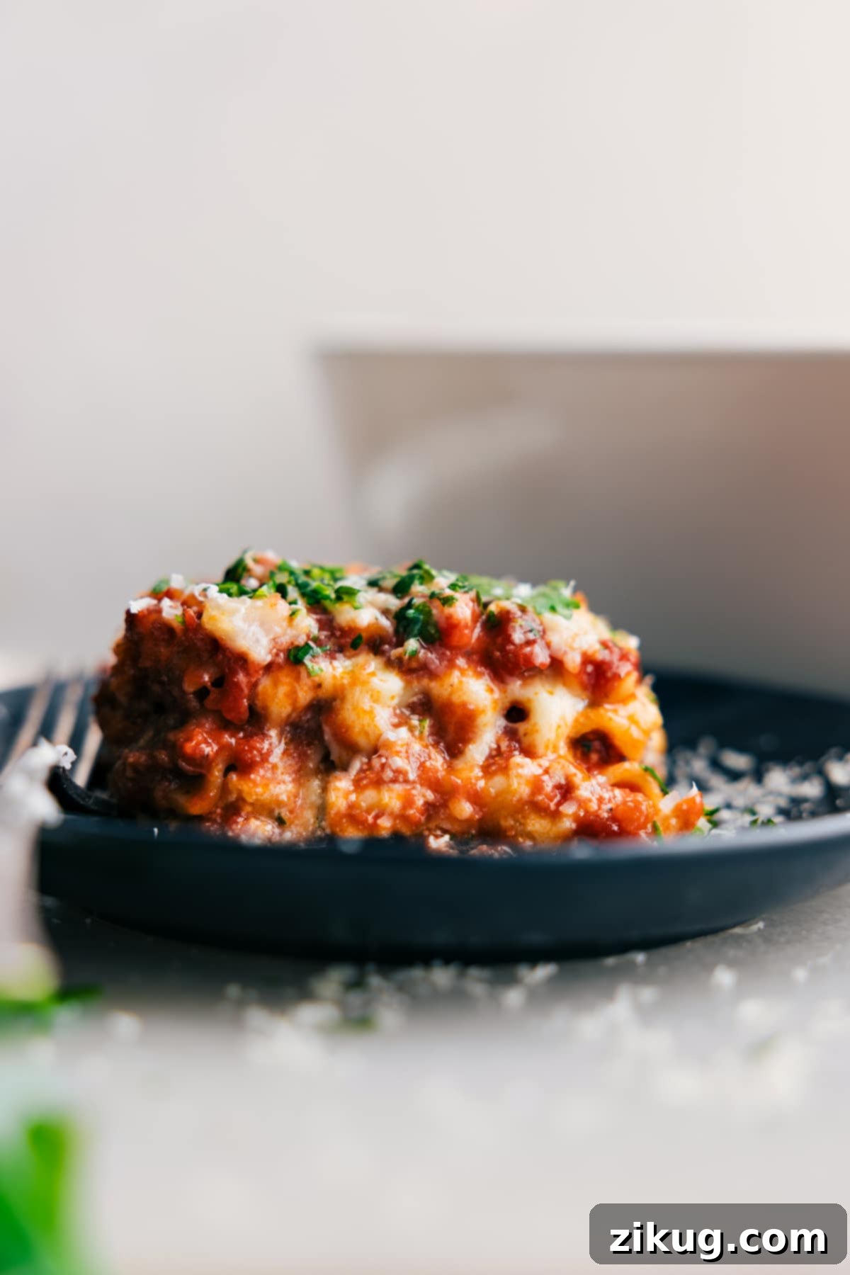 Perfect Homemade Lasagna Slice Steaming slice of Lasagna layered with cheese and sauce on a plate, ready to eat.