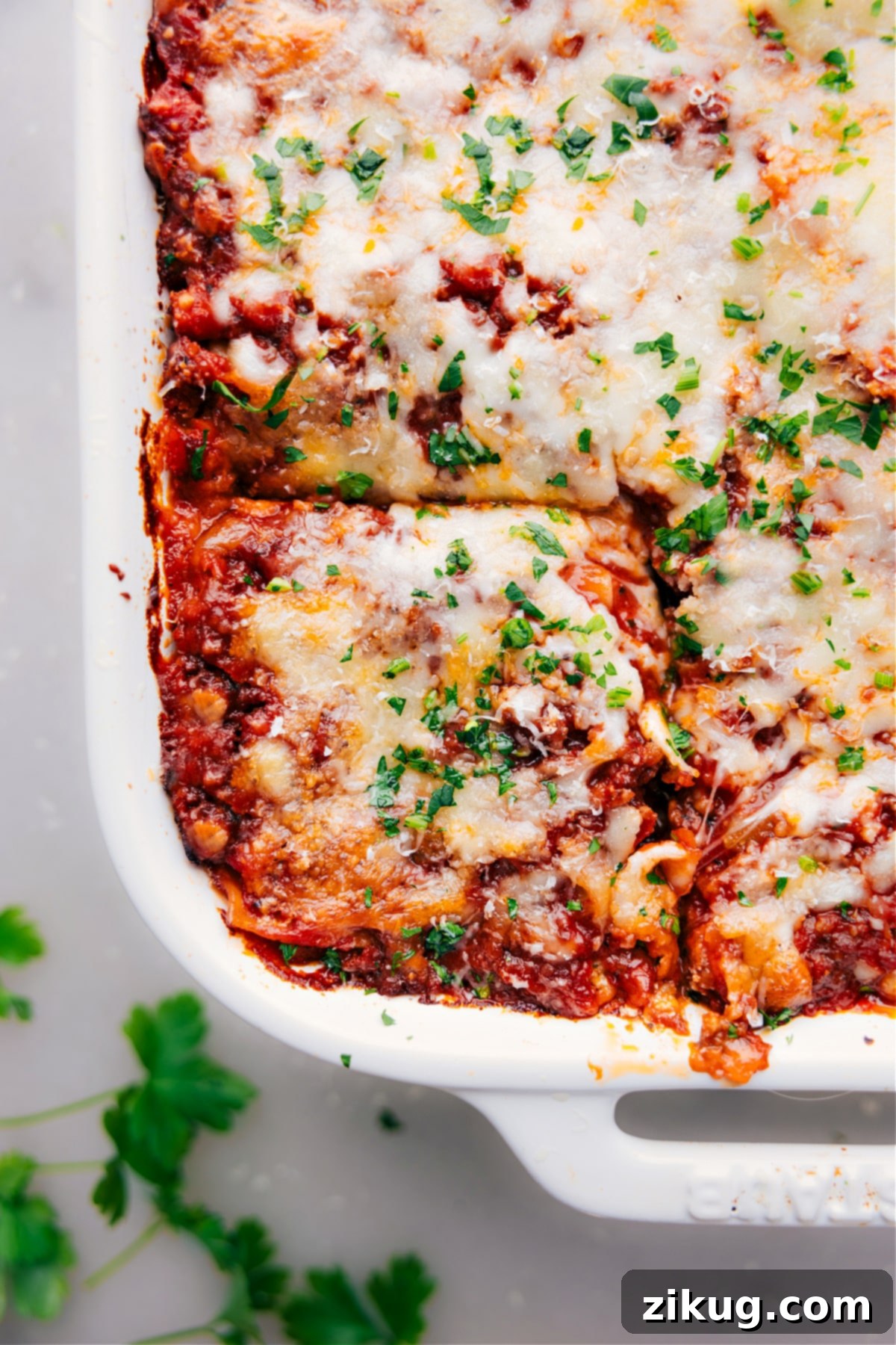 Sliced Lasagna in 9x13 Dish Lasagna in a 9x13 with one piece sliced and ready to be removed