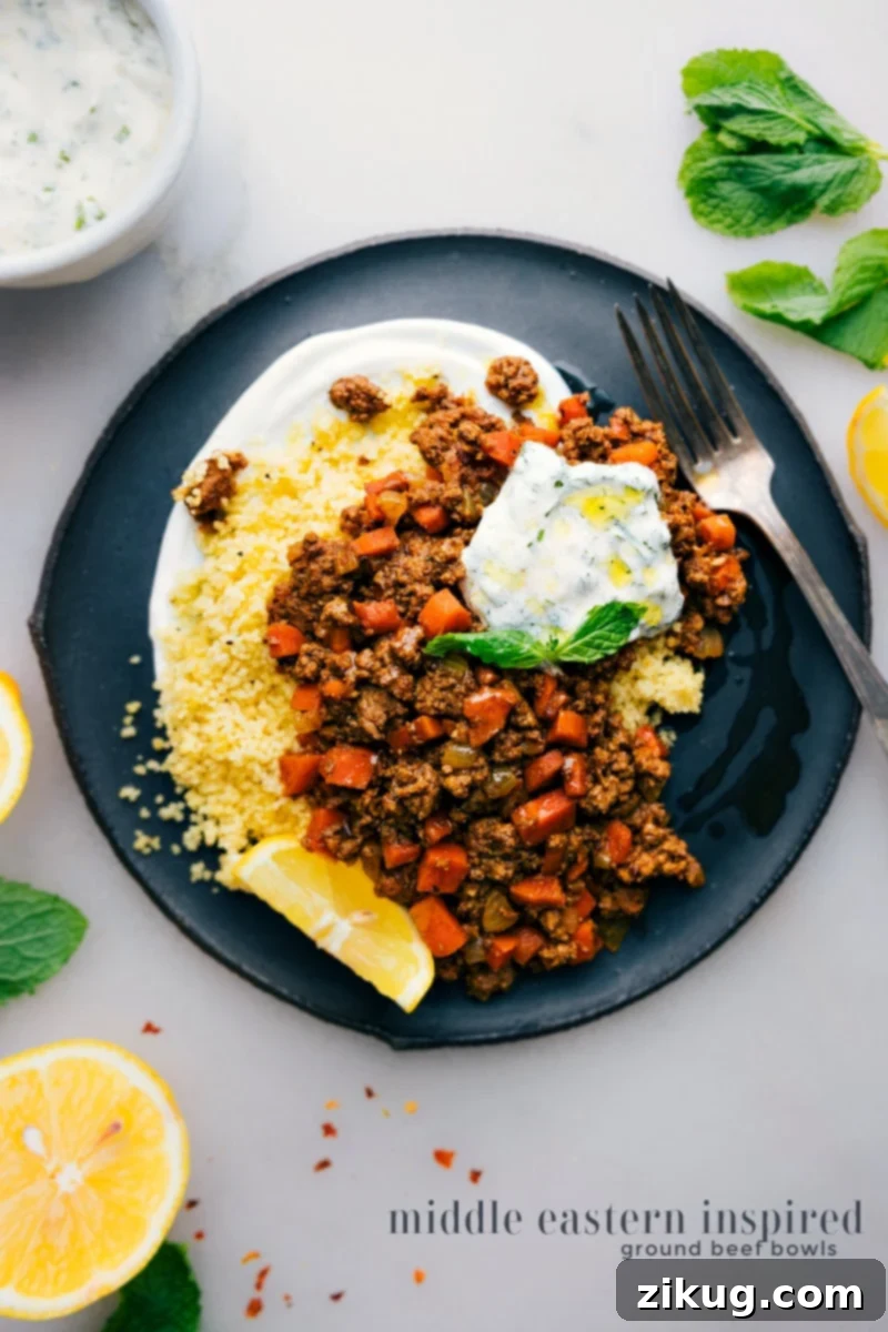 Delicious Middle Eastern Ground Beef Bowls with warming spices, sweet vegetables, and a refreshing mint-yogurt sauce, ready in 30 minutes. Overhead view of vibrant Middle Eastern Ground Beef Bowls, showcasing spiced beef, couscous, and mint-yogurt sauce