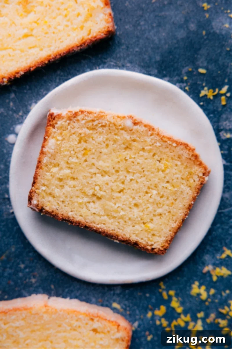 Overhead image of a slice of Lemon Bread on a plate, perfectly glazed and ready to eat.