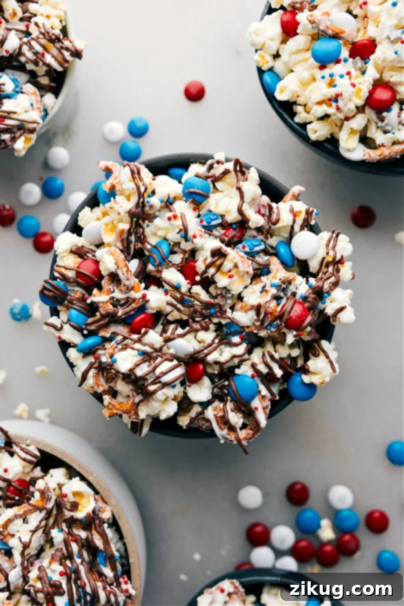 Bowl of 4th of July Popcorn with red, white, and blue candy and pretzels, ready to be enjoyed as a festive snack.