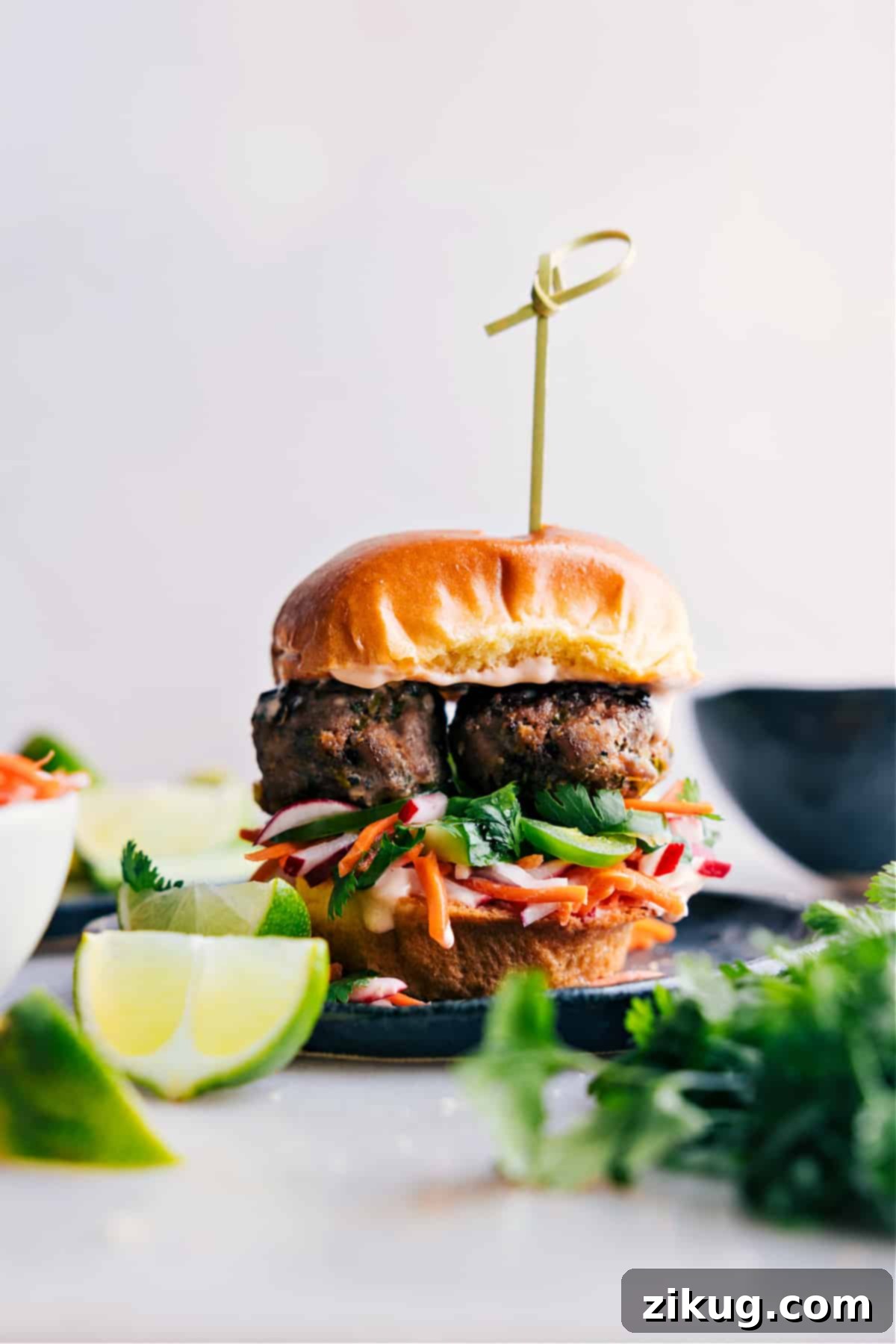 Mouth-watering slider brimming with succulent banh mi meatballs and crisp vegetables, fully assembled and ready to delight.