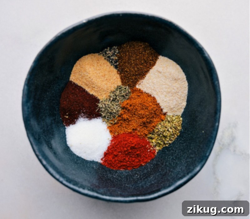These essential spices are carefully chosen for this Blackening Seasoning recipe, creating a versatile, smoky, and spicy blend perfect for forming a flavorful crust on grilled or pan-fried dishes, enhancing meats, fish, and vegetables. A curated selection of individual spices, including vibrant red paprika, green dried herbs, and dark peppercorns, neatly arranged and ready for blending into the blackened seasoning.