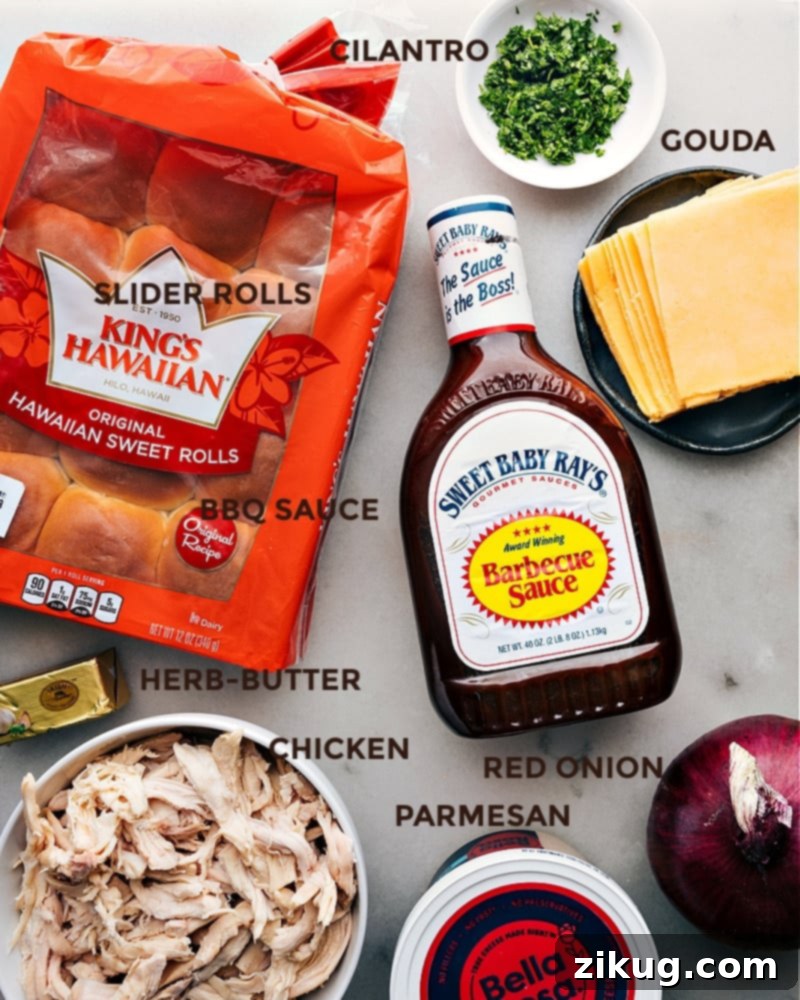 These BBQ Chicken Sliders combine juicy BBQ chicken, melty Gouda cheese, and sweet Hawaiian rolls, all jazzed up with a pop of onion and cilantro. The rolls are brushed with garlic-herb butter that gives these sliders a beautiful crispy and golden exterior. Recipe via ChelseasMessyApron.com #BBQ #BBQchicken #sliders #hawaiianrolls #quick #easy Assortment of fresh ingredients laid out for making BBQ Chicken Sliders