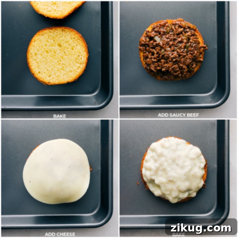 Assembling and baking Philly Cheesesteak Sloppy Joes with beef and melted provolone on toasted buns. The final stages of preparing Philly Cheesesteak Sloppy Joes: Hot beef mixture is spread on toasted brioche buns, topped with provolone cheese, and baked until the cheese is melted and golden brown.