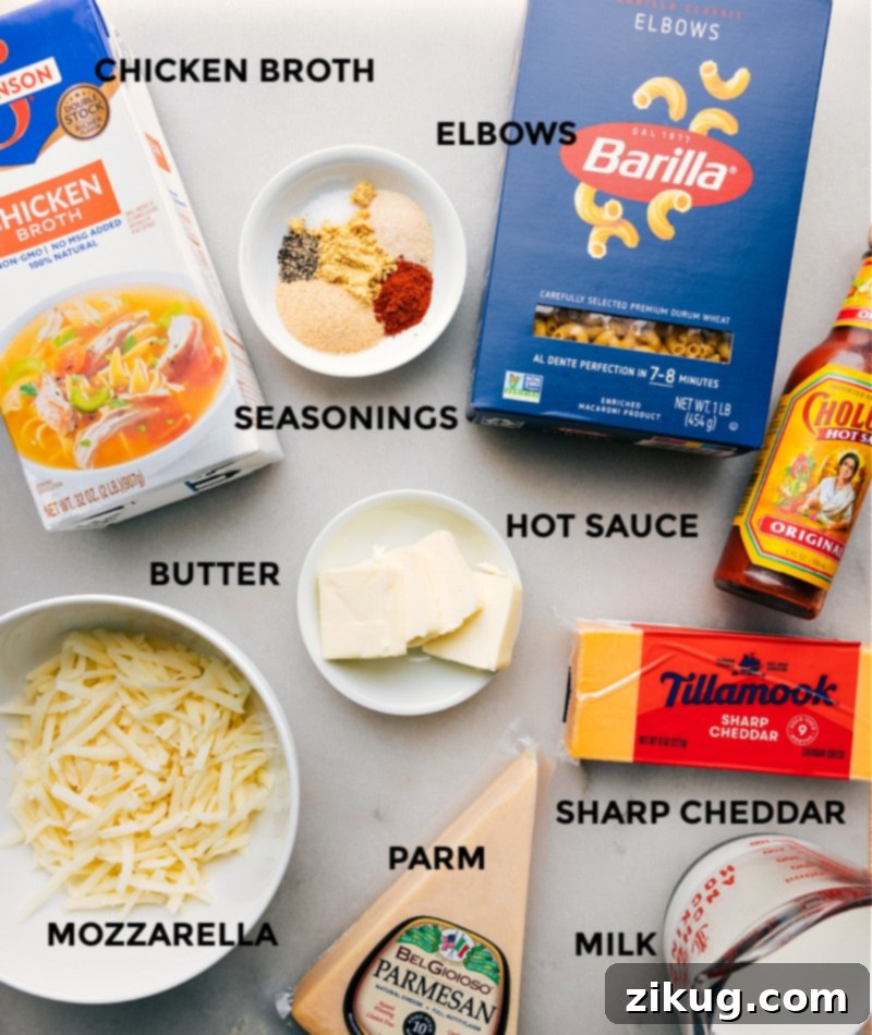 A selection of fresh ingredients laid out, including elbow pasta, chicken broth, various cheeses, and seasonings, ready for Instant Pot Mac and Cheese.