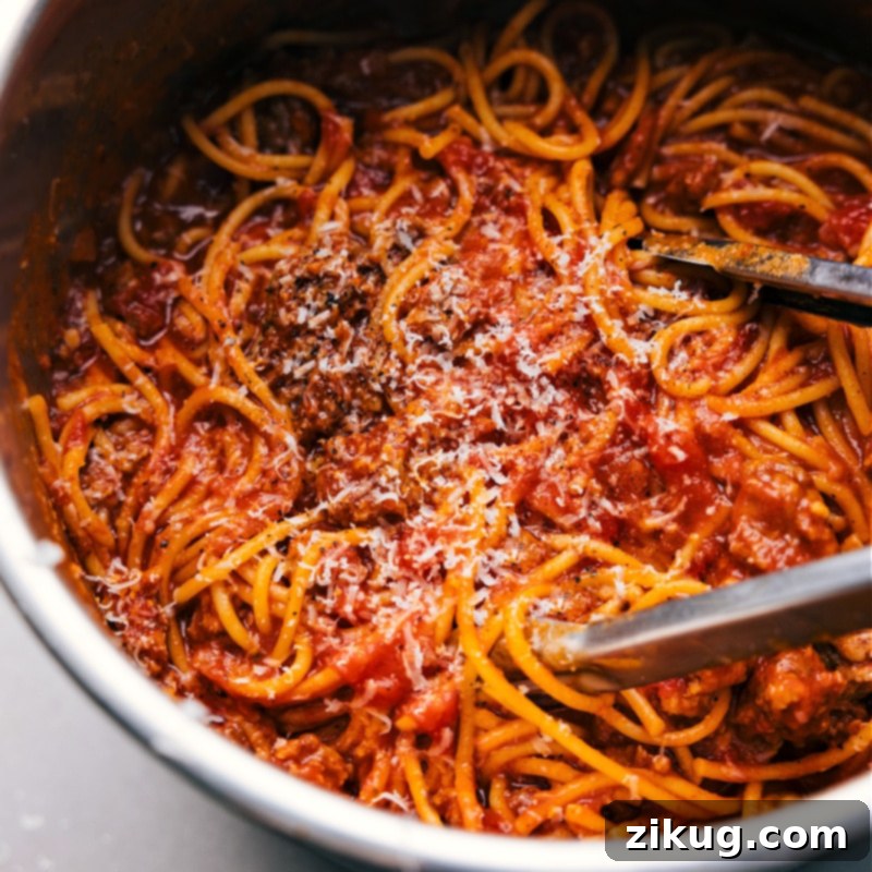 Delicious Instant Pot Spaghetti, ready to serve. A vibrant, close-up overhead shot of the Instant Pot Spaghetti resting in the pot, ready to be scooped and enjoyed, highlighting its rich sauce and inviting texture.