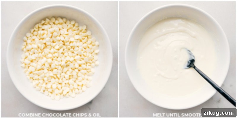 Watch the magic happen as creamy white chocolate is perfectly melted, ready to coat our delicious Popcorn Snack Mix. This no-bake recipe is quick, easy, and yields an irresistible sweet and salty treat. Recipe via chelseasmessyapron. Close-up shot of white chocolate being melted in a bowl, highlighting the smooth, creamy texture.