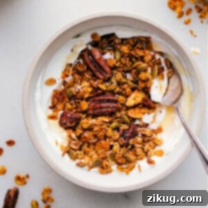 A bowl of freshly baked Pumpkin Granola with nuts, seeds, and oats, ready to be served.
