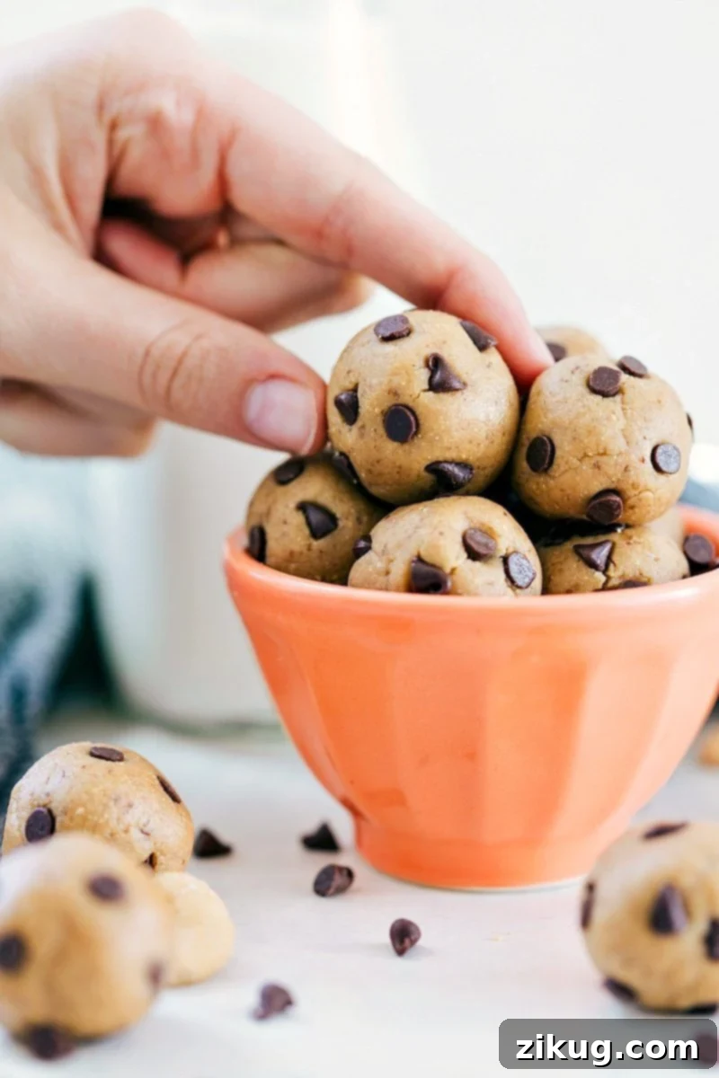 Quick & Easy 4-Ingredient No-Bake Energy Bites: Healthy Cookie Dough Alternative Close-up of freshly made No-Bake Energy Bites with visible chocolate chips on a white plate