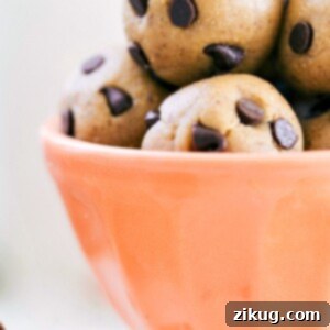 4-Ingredient No-Bake Energy Bites 2 Close-up of three No-Bake Energy Bites stacked, showing their chewy texture and chocolate chips