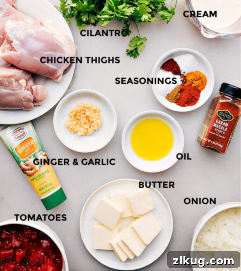Dreamy Instant Pot Butter Chicken 3 Array of ingredients assembled for the instant pot butter chicken recipe, including spices, chicken, tomatoes, and cream.
