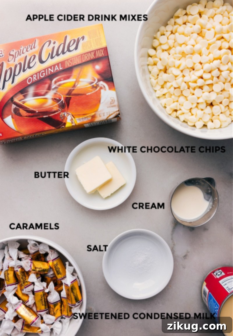 Essential ingredients for Caramel Apple Fudge: caramels, heavy cream, butter, apple cider mix, white chocolate chips, sweetened condensed milk, and sea salt. A flat lay photograph displaying all the fresh and packaged ingredients needed to prepare Apple Cider Fudge, including caramels, heavy cream, butter, drink mix, white chocolate, condensed milk, and salt.