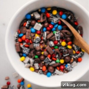 Candy Salad featuring a vibrant mix of Whoppers, Reese's, and chocolate-covered pretzels.