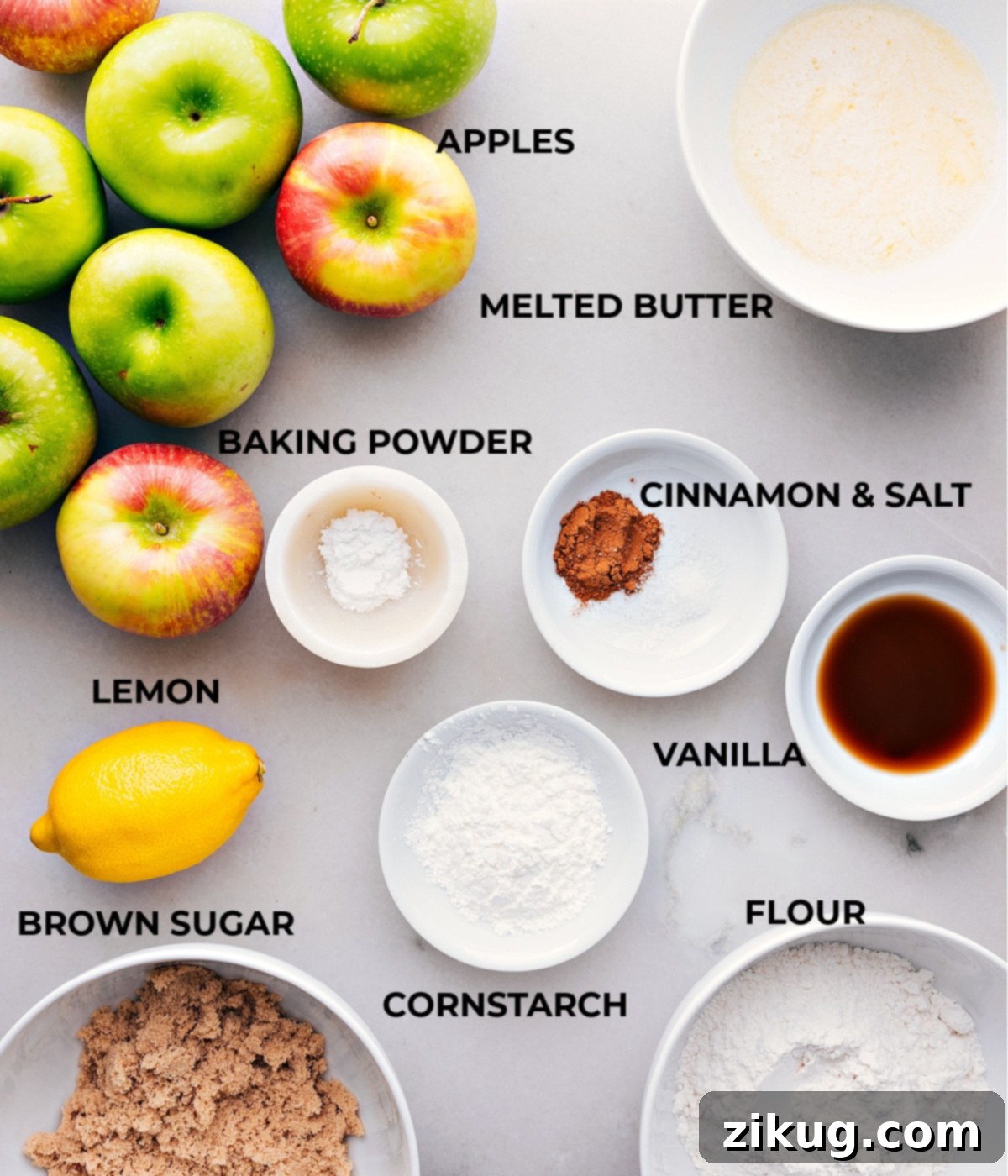 Essential Ingredients for a Delicious Apple Cobbler A beautiful spread of fresh ingredients for apple cobbler, including sliced apples, brown sugar, cinnamon, flour, butter, and vanilla extract.