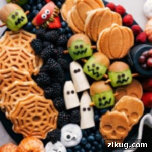 A vibrant display board showcasing a variety of easy and fun Halloween-themed breakfast ideas, including monster fruits, festive waffles, and spooky treats.