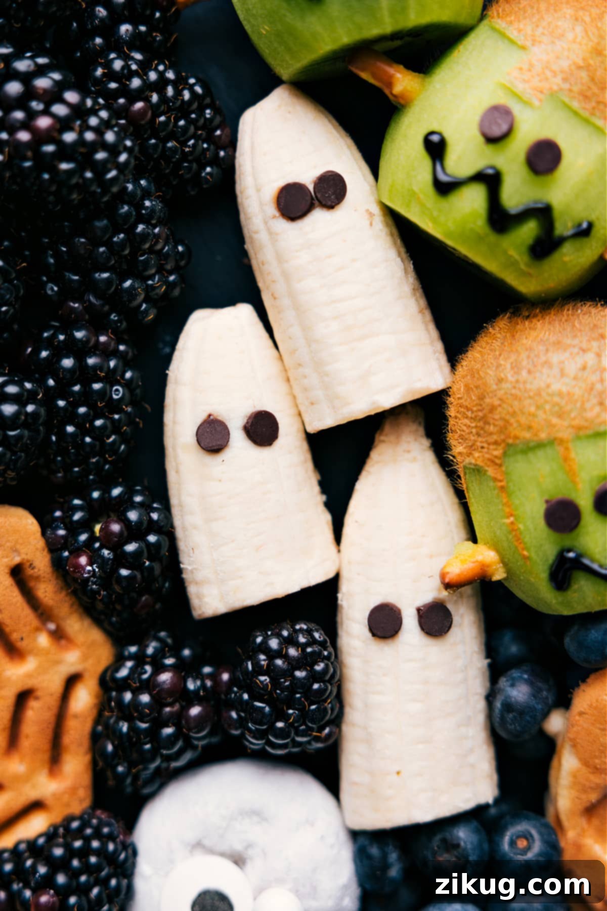 A creative and simple Halloween breakfast idea: a banana ghost with chocolate chip eyes, displayed on a serving tray.