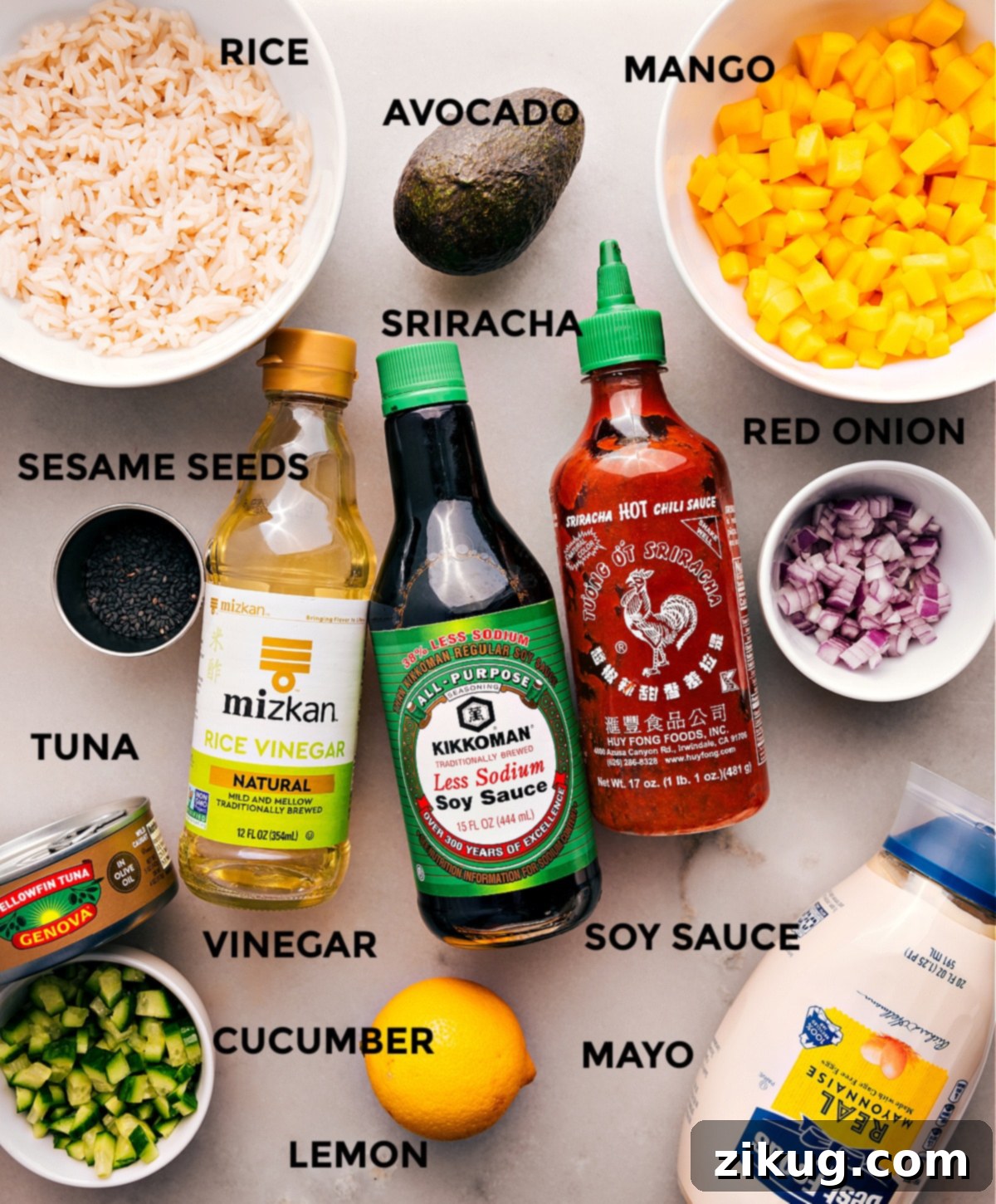 All the ingredients are prepped for easy assembly—mango, onion, soy sauce, sriracha, rice vinegar, rice, avocado, sesame seeds, tuna, cucumber, mayo, and lemon.