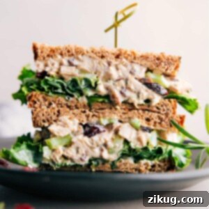 Scrumptious rosemary chicken salad sandwich, halved to reveal its generous, flavorful filling.