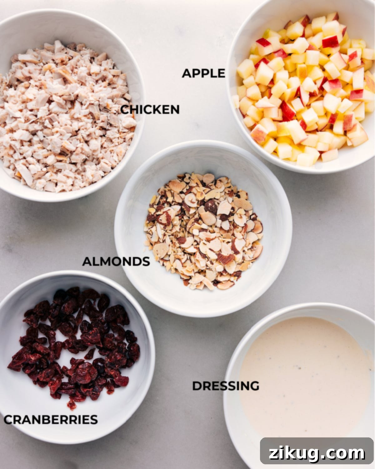 Ingredients In Chicken Salad With Apples Assorted ingredients for a recipe displayed on a board, ready for preparation.