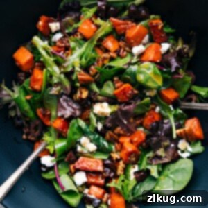 Creamy Sweet Potato Salad 2 A vibrant bowl of sweet potato salad, featuring diced roasted sweet potatoes mixed with various colorful ingredients.