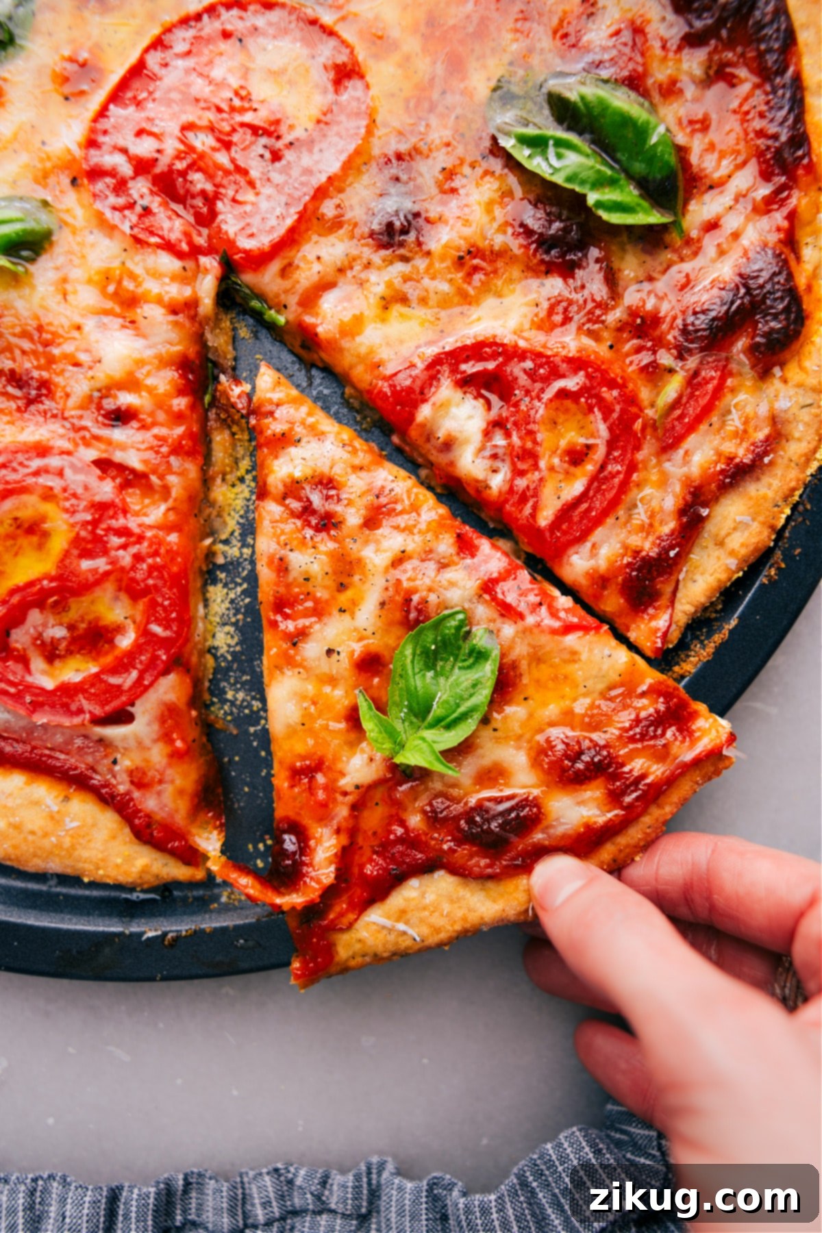 Slice of heaven: Freshly baked No-Yeast Pizza straight from the oven, ready to enjoy Freshly baked No-Yeast Pizza with a slice being lifted out, showing the melted cheese and crispy crust.