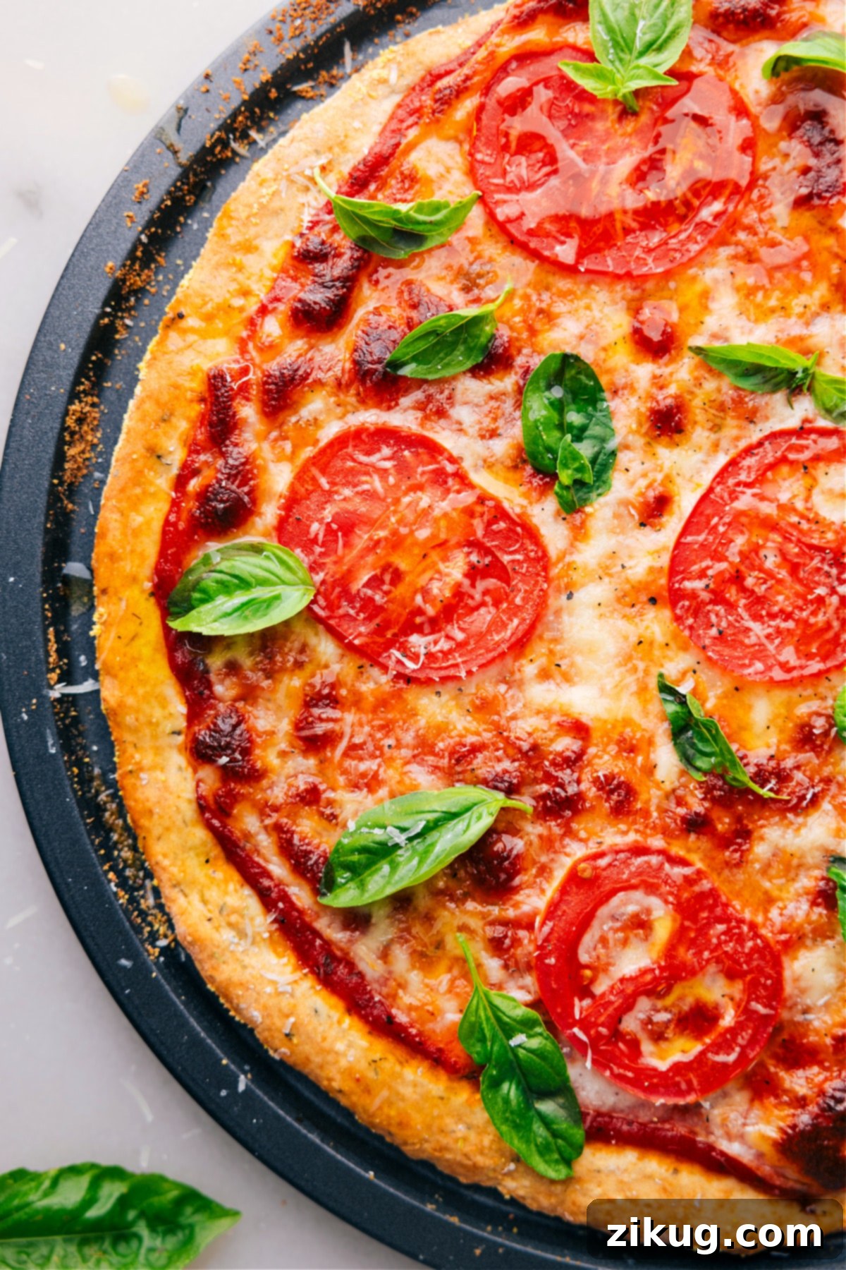 Get ready for a feast with this No-Yeast Pizza! Mangia! Overhead view of a pizza made with No-Yeast Pizza Dough, cut into slices and garnished with fresh basil, ready to be served.