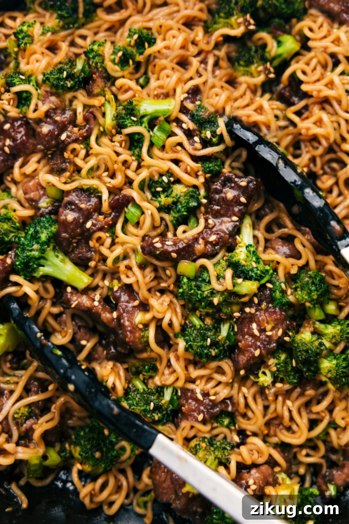 Top Your Beef And Broccoli Ramen With Green Onions And Sesame Seeds Beef and broccoli ramen in the pot with sesame seeds and green onions as garnish.