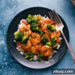 A close-up of Honey Garlic Shrimp with broccoli, coated in a glossy sauce, ready to serve.