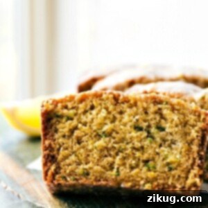 The delicious and flavorful lemon zucchini bread cut into slices, showing its moist texture and vibrant lemon glaze.