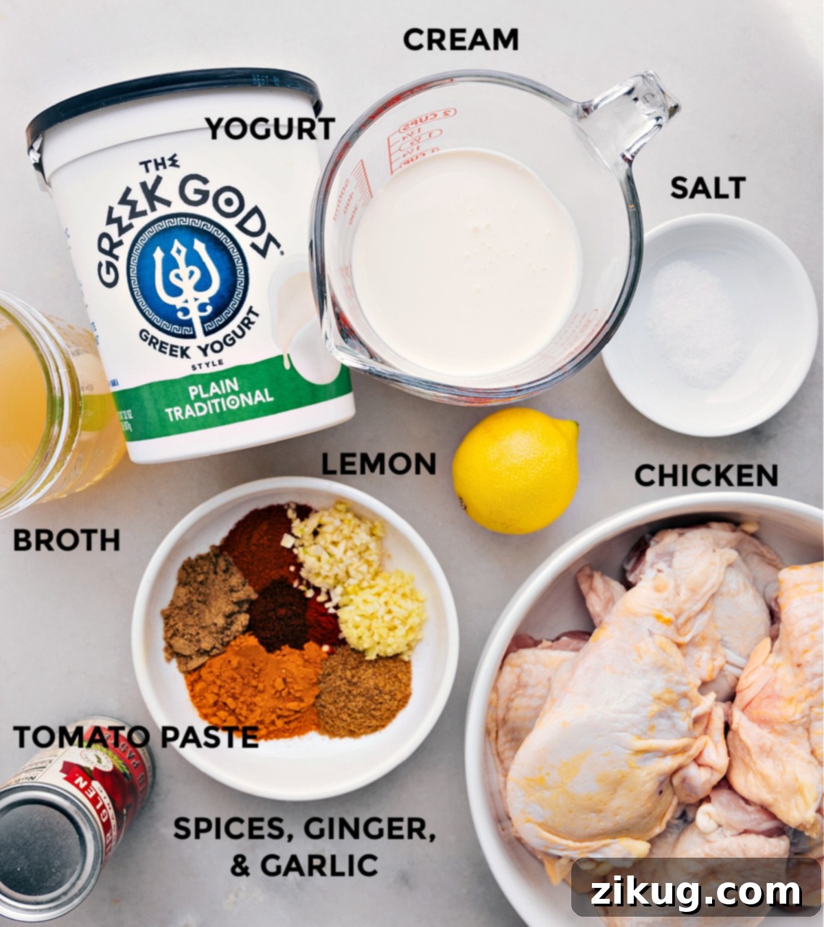 Essential Ingredients: Premium Chicken, Aromatic Spices, Yogurt, Cream, and Fresh Produce for Tikka Masala A selection of fresh and vibrant ingredients laid out, including chicken thighs, various aromatic spices, creamy Greek yogurt, rich heavy cream, and zesty lemons, all prepared for a delicious Tikka Masala recipe.