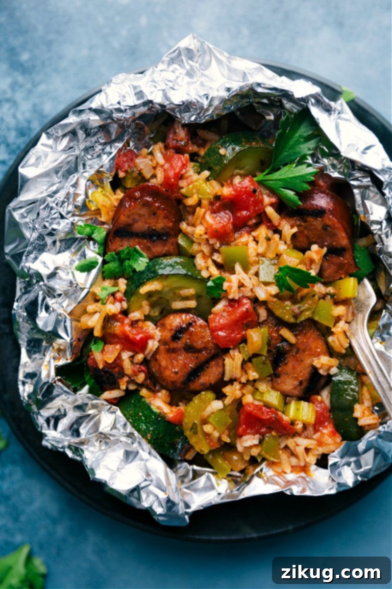 Tin Foil Jambalaya packets: A simple, incredibly delicious, and remarkably versatile meal, perfectly prepared and ready for your oven, grill, or campfire, promising both flavor and ease. An inviting overhead view of four perfectly cooked and securely sealed individual Tin Foil Jambalaya packets, showcasing the simplicity, convenience, and readiness of this easy meal solution, ideal for family dinners or outdoor adventures.