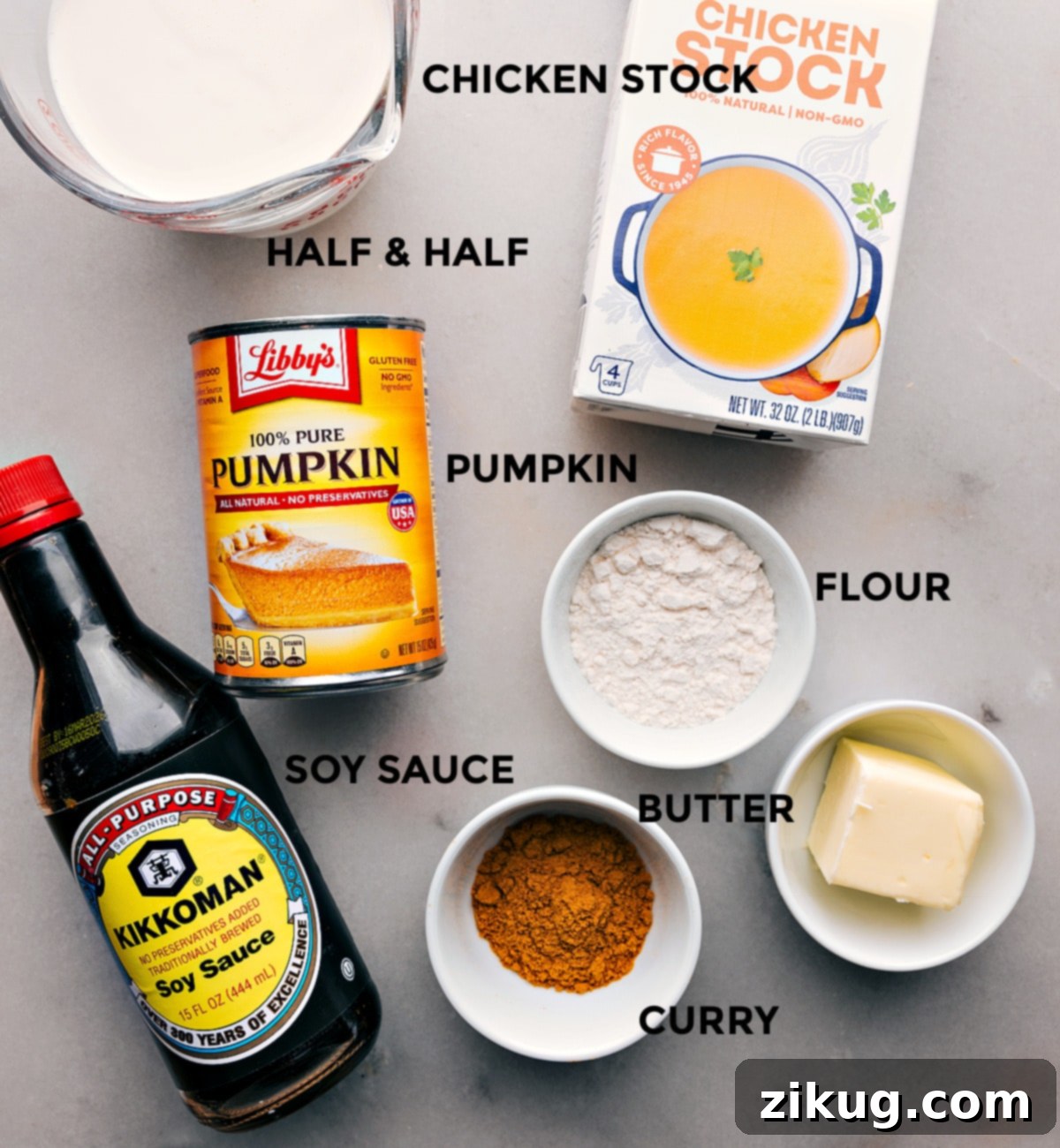 A collection of fresh ingredients for Pumpkin Curry Soup laid out neatly on a kitchen counter, ready for preparation.
