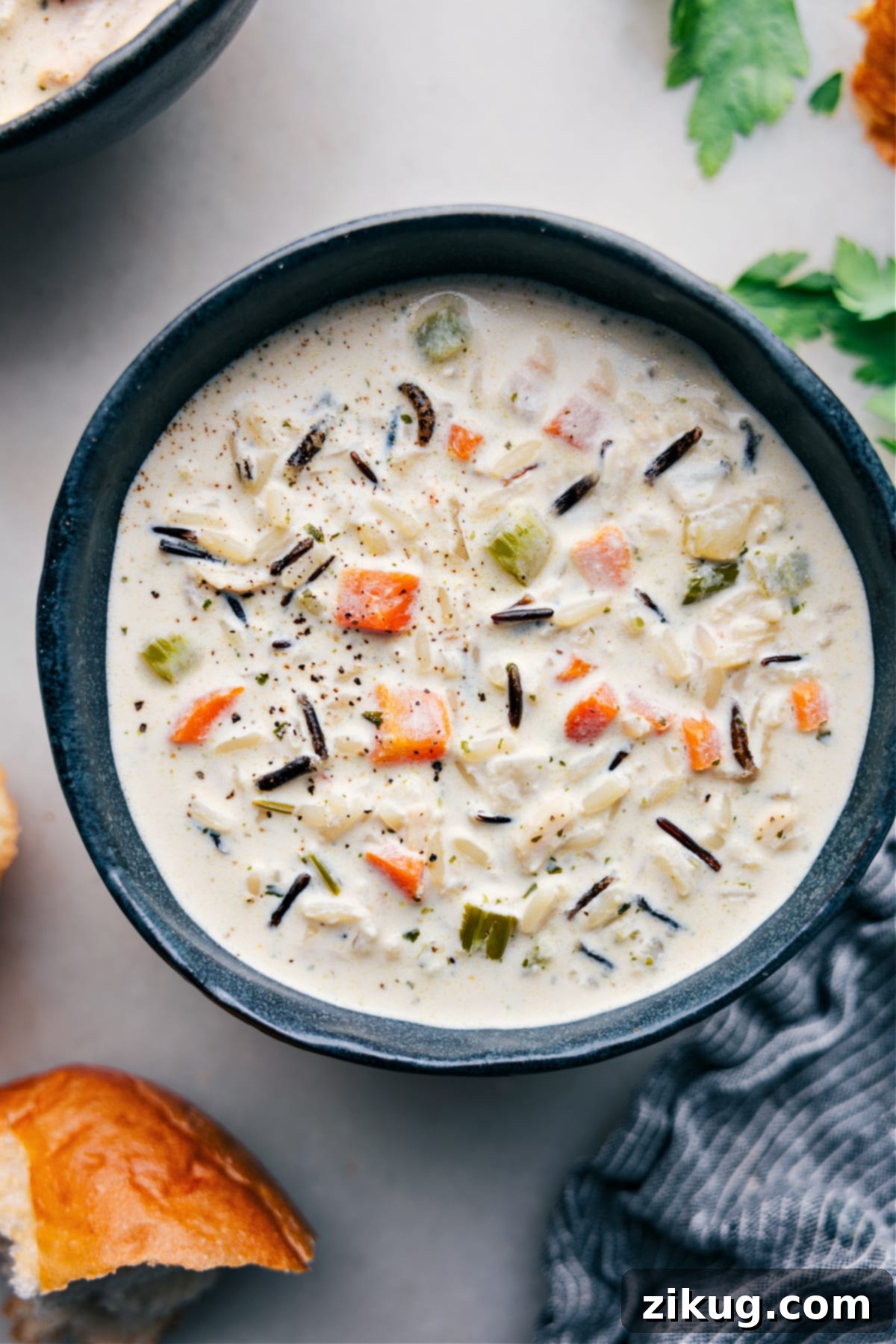 Delicious and Hearty Creamy Chicken And Wild Rice Soup A steaming bowl of Creamy Chicken and Wild Rice Soup, garnished and ready to be enjoyed on a cozy evening.