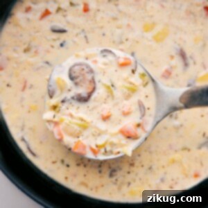Creamy and rich artichoke soup, with a wooden ladle scooping out a steaming serving ready to be enjoyed.