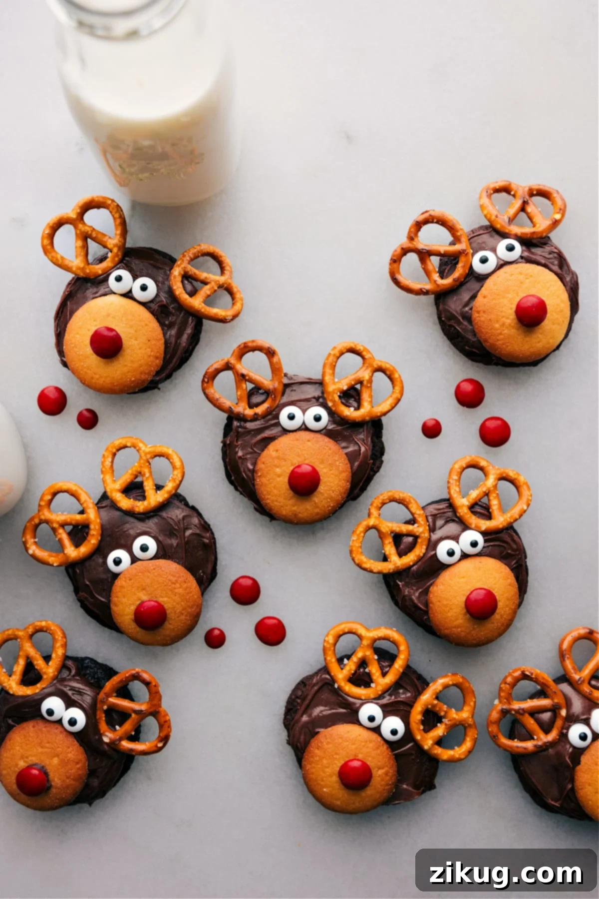 Festive Reindeer Cookies: Easy & Fun Holiday Baking Adorable and delicious Reindeer Cookies decorated with pretzel antlers, candy eyes, and a bright red nose, perfect for festive dessert tables and holiday celebrations.