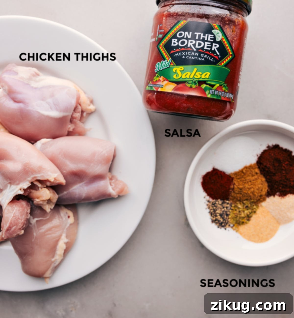 Fresh and pantry ingredients laid out for making Salsa Chicken in a Crockpot, including salsa, chicken thighs, and various spices.