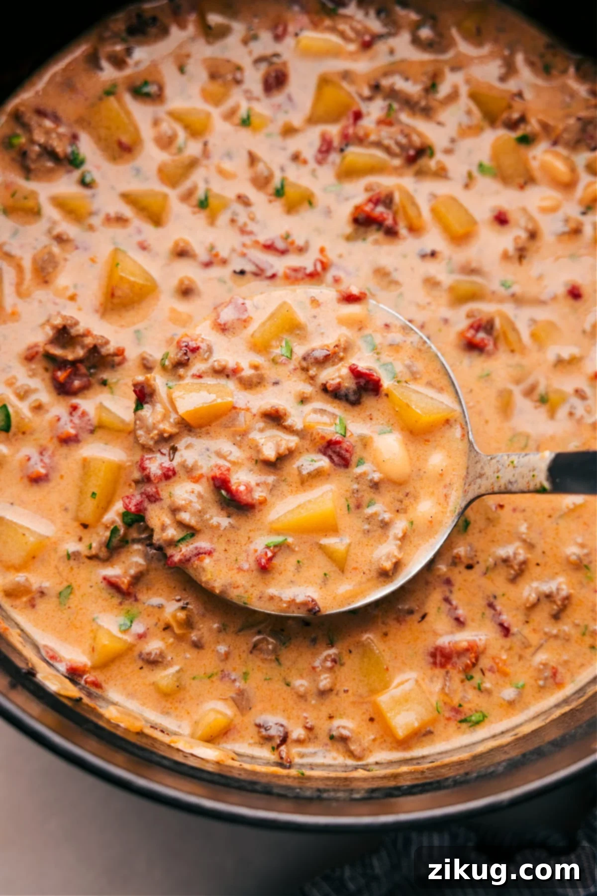 Pan of Finished Tuscan Sausage & Potato Soup A pan filled with the finished Tuscan Sausage and Potato soup, full of flavor and ingredients, warm and ready to be enjoyed as a delicious meal.