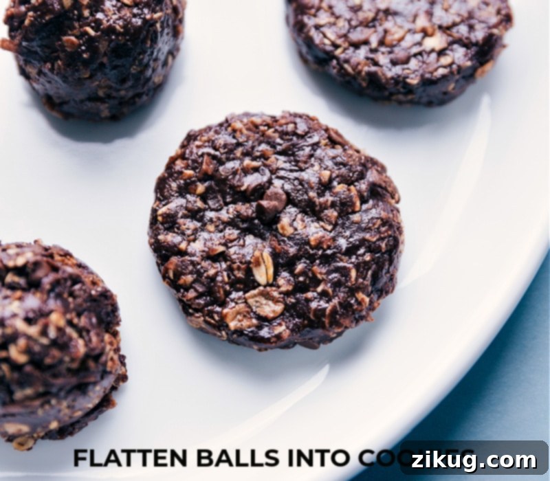 Chocolate-Peanut Butter Breakfast Cookies are loaded with delicious and satiating ingredients! Recipe via ChelseasMessyApron Chocolate-Peanut Butter Breakfast Cookies being flattened into perfect circular shapes on parchment paper