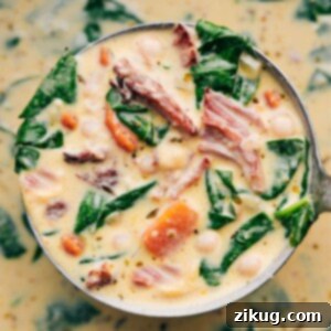 A comforting bowl of creamy Ham and Bean Soup, garnished with fresh herbs and a slice of crusty bread on the side.