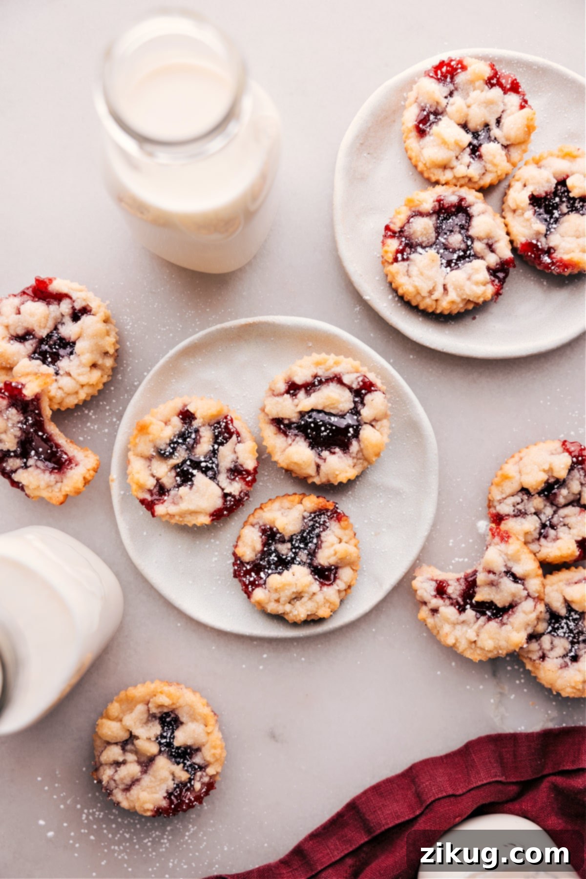 The Best Costco's Raspberry Crumble Cookies Costco's Raspberry Crumble Cookies spread out on some plates.