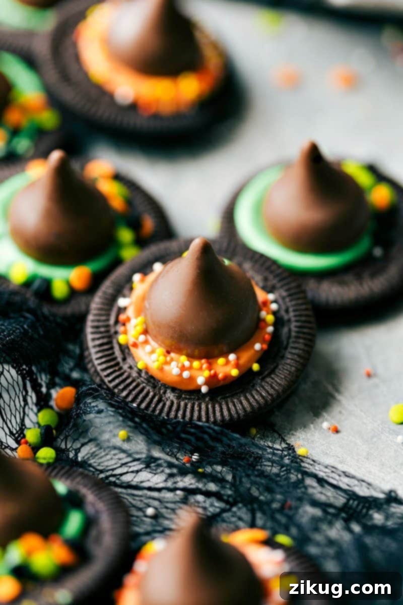 A vibrant assortment of homemade Witch's Hats, Monster Eyeballs, and Bat Bites arranged on a board, ready for a Halloween celebration.