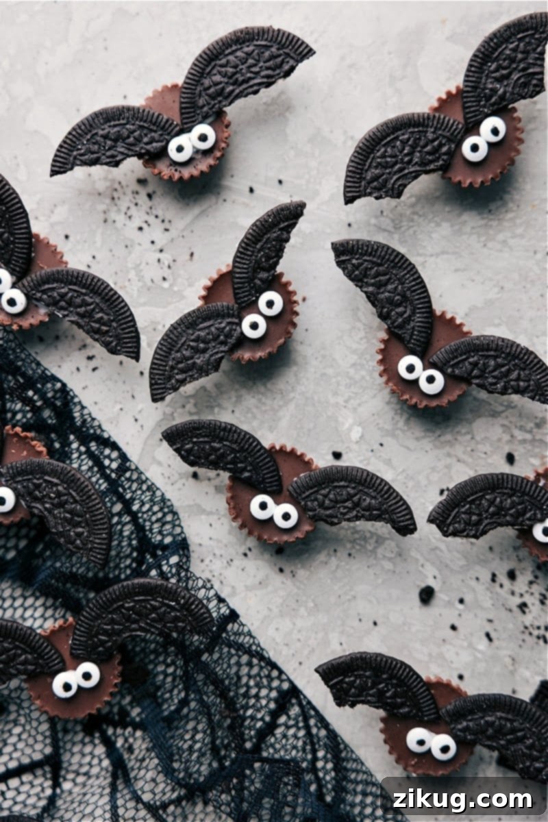An overhead view of Bat Bites, showcasing their Reese's cup body, Oreo wings, and small candy eyes, ready for a Halloween party.